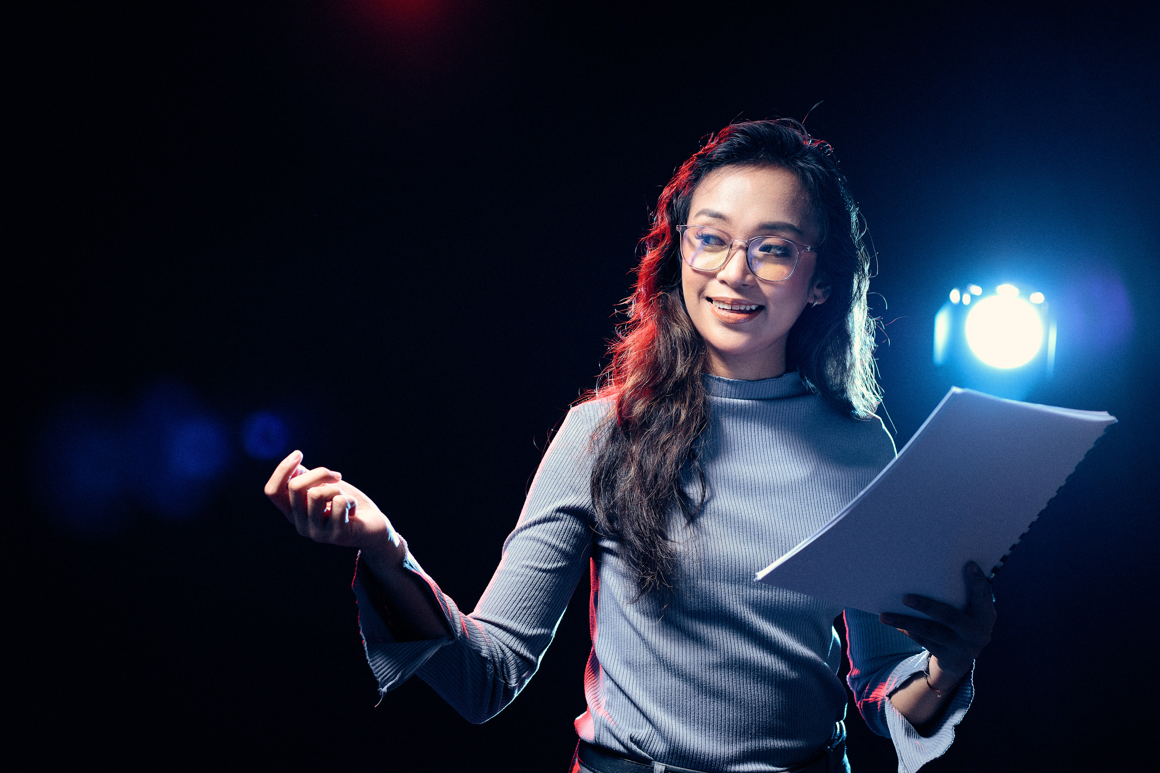 Woman Giving a Talk in Public on Stage